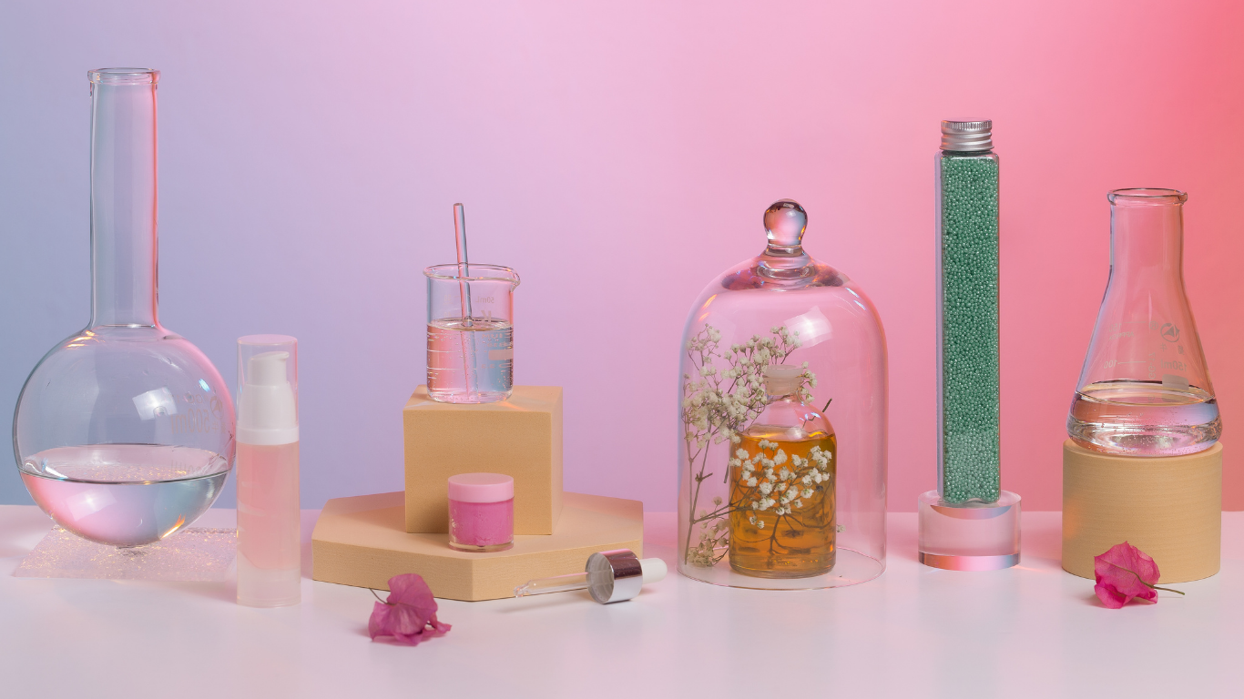 Laboratory glassware, serum bottles and botanical samples on a pastel gradient backdrop